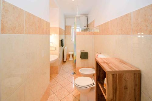 a bathroom with a toilet and a sink at Apartment Pula 43 in Veruda
