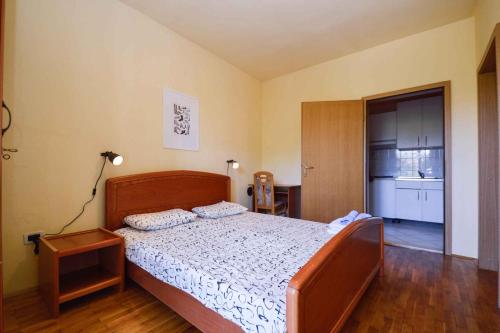 a bedroom with a bed and a room with a kitchen at Apartments in Pjescana Uvala/Istrien 10996 in Pješčana Uvala