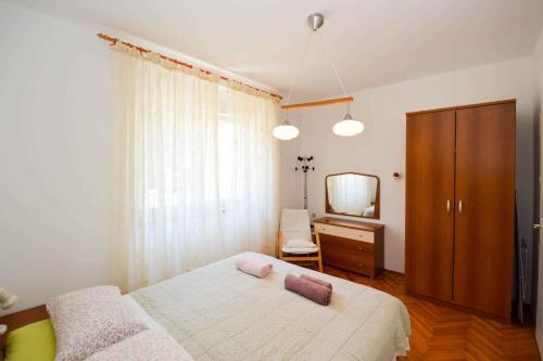 1 dormitorio con cama, tocador y espejo en Pula Apartment 11 en Veruda