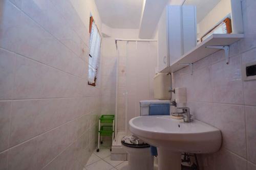 a white bathroom with a sink and a toilet at Apartments in Pjescana Uvala/Istrien 10996 in Pješčana Uvala