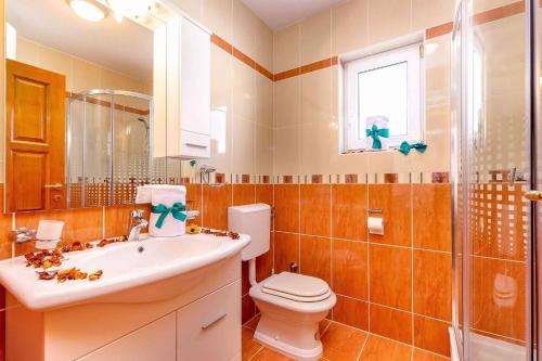 a bathroom with a toilet and a sink and a shower at Crikvenica Apartment 2 in Dramalj