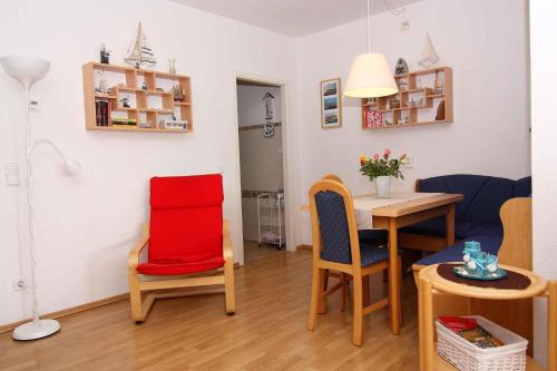 a small living room with a table and chairs at Wendtorf Apartment 2 in Wendtorf
