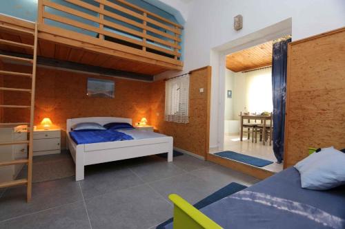a bedroom with a bunk bed and a ladder at Studio in Silo/Insel Krk 13449 in Šilo