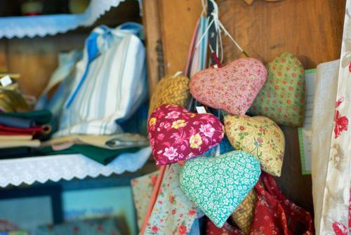 a bunch of hearts hanging on a wall at Logis Hotel Restaurant La Porte des Cévennes in Anduze