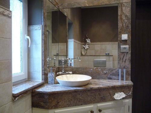a bathroom with a sink and a large mirror at Holiday home in Coswig 3105 in Möllensdorf