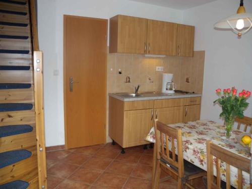 a small kitchen with a table and a sink at Apartment in Morgenitz/Insel Usedom 3207 in Dewichow