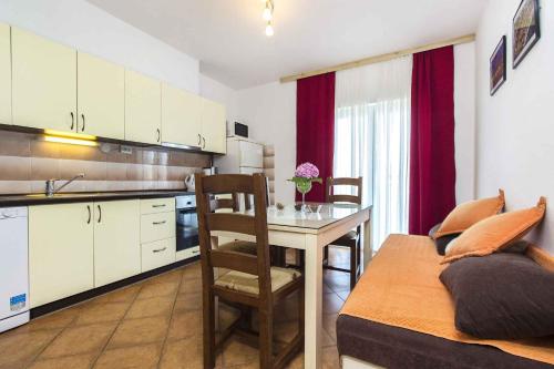 a kitchen with a table and a dining room at Apartment Slatine 6 in Trogir