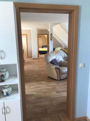 a living room with a couch and a mirror at Apartment Gingst 1 in Gingst