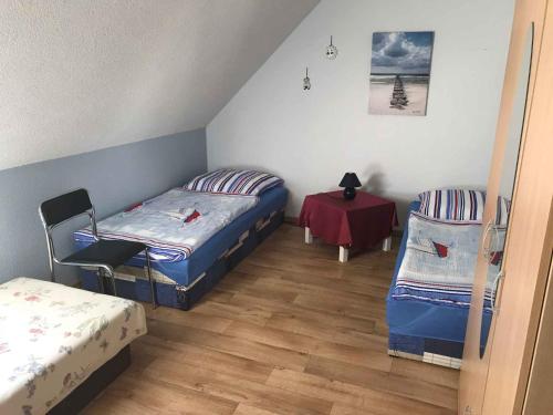 a room with two beds and a table in it at Apartment Gingst 1 in Gingst