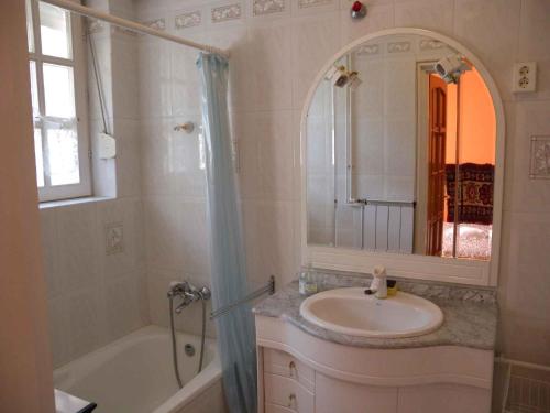 a bathroom with a sink and a tub and a mirror at Holiday home in Siofok/Balaton 19877 in Siófok