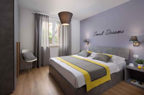 a bedroom with a bed and a sign that readsjust breathe at Apartment Rabac 11 in Rabac