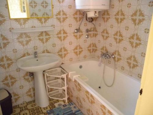 ein Badezimmer mit einem Waschbecken, einer Badewanne und einem Waschbecken in der Unterkunft Holiday home in Balatonmariafürdo 19400 in Balatonmáriafürdő