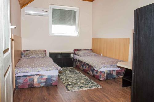 a room with two beds and a window at Holiday home Balatonkeresztur 13 in Balatonkeresztúr