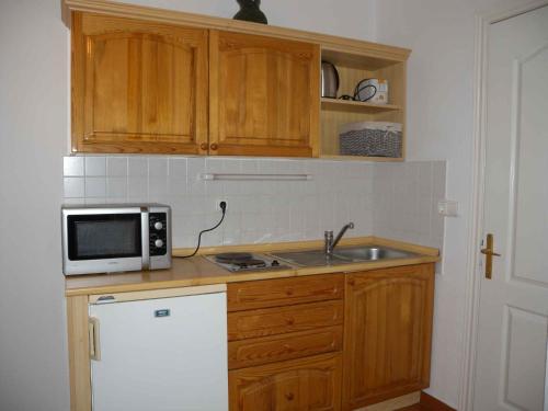 a kitchen with a sink and a microwave at Apartment in Balatonlelle/Balaton 19176 in Balatonlelle