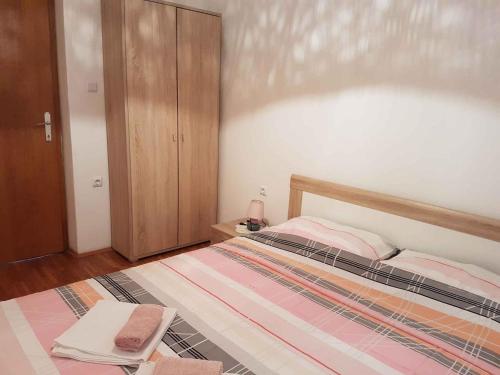 a bedroom with a large bed with a wooden headboard at Apartment in Silo/Insel Krk 13496 in Šilo