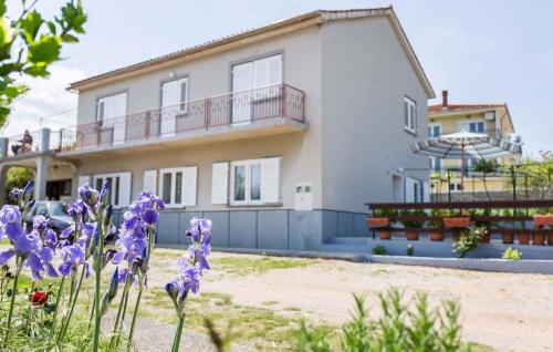 a house with purple flowers in front of it at Apartment in Silo/Insel Krk 13509 in Šilo