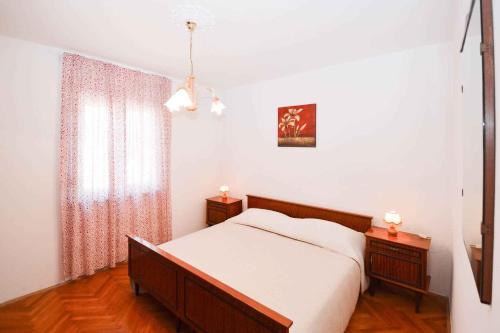a bedroom with a bed and two night stands at Apartment in Medulin/Istrien 9070 in Medulin