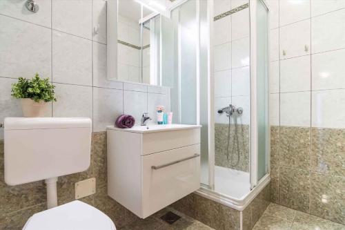 a bathroom with a shower and a toilet and a sink at Apartment Rabac 12 in Rabac