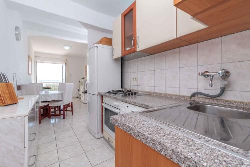 a kitchen with a sink and a counter top at Apartment Okrug Gornji, Ciovo 2 in Trogir