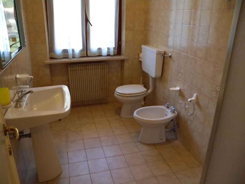 a bathroom with a toilet and a sink at Apartment Pieve di Ledro 3 in Ledro