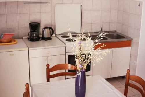 a blue vase sitting on a table in a kitchen at One-Bedroom Apartment Novi Vinodolski near Sea 7 in Povile