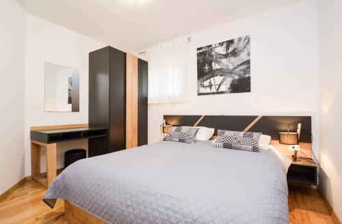 a bedroom with a large bed and a desk at Apartment Pula, Brijuni, Istria 2 in Veruda