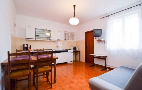 a kitchen and dining room with a table and a dining room at Apartment Fazana 28 in Fažana