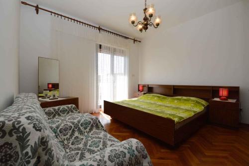 a bedroom with two beds and a large window at Apartment Medulin 6 in Medulin