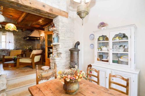 a dining room with a table and a stone wall at Holiday home in Liznjan/Istrien 8962 in Ližnjan