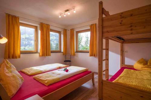 1 Schlafzimmer mit 2 Etagenbetten und 2 Fenstern in der Unterkunft Apartment Zell am Ziller/Zillertal 841 in Zell am Ziller