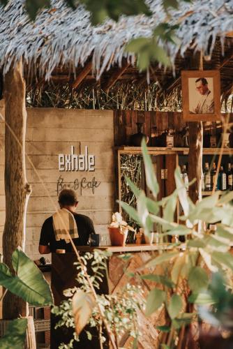 a man standing at a counter in a restaurant at Inhale @ Hill in Koh Mook