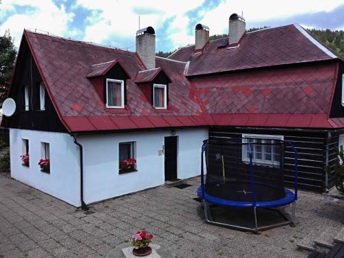 a house with a red roof and a basketball hoop at Holiday home in Josefuv Dul 1726 in Josefuv dul