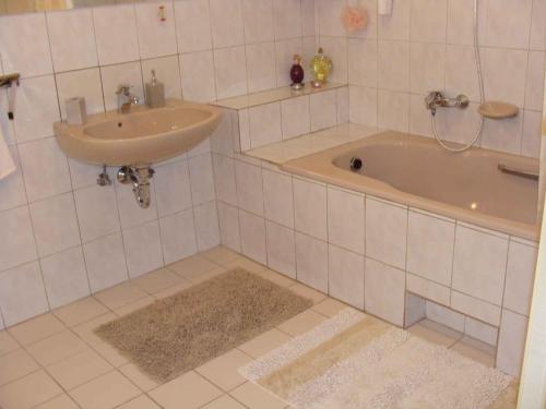 a bathroom with a sink and a tub at Apartment Gyenesdias 15 in Gyenesdiás