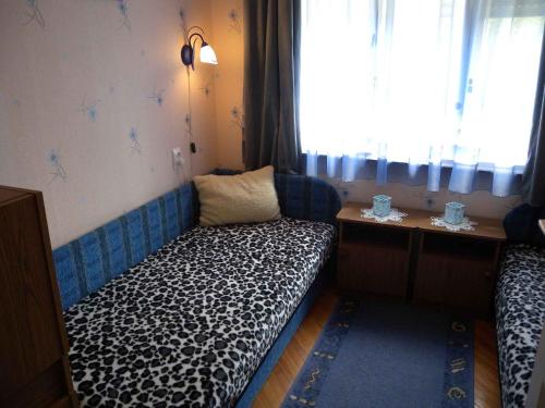 a small room with a couch with a window at Holiday home in Fonyod - Balaton 18592 in Fonyód