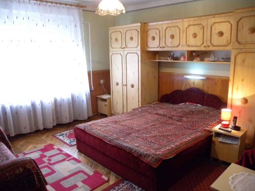 a bedroom with a bed with a red bedspread at Holiday home in Balatonfenyves 18379 in Balatonfenyves