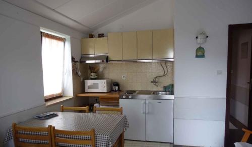 a small kitchen with a table and a microwave at Apartment in Pula/Istrien 10835 in Vintijan