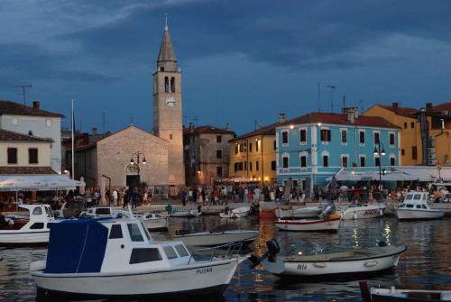 a group of boats in a harbor with a clock tower at Apartment Fazana, Istria 16 in Fažana