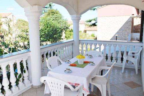 a white table and chairs on a balcony at Holiday home in Muntic - Istrien 10956 in Muntić