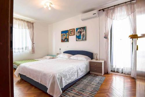 a bedroom with a large bed and a large window at Apartment in Banjole/Istrien 11157 in Banjole
