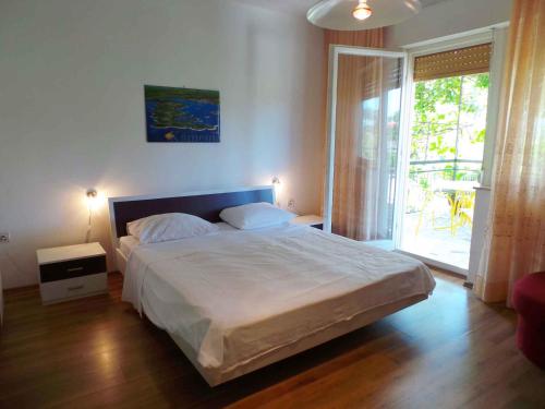 a bedroom with a large bed and a large window at Holiday home in Banjole/Istrien 10808 in Banjole