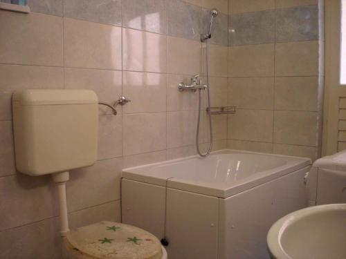 a bathroom with a tub and a toilet and a sink at Holiday home in Slatine/Insel Ciovo 6128 in Slatine