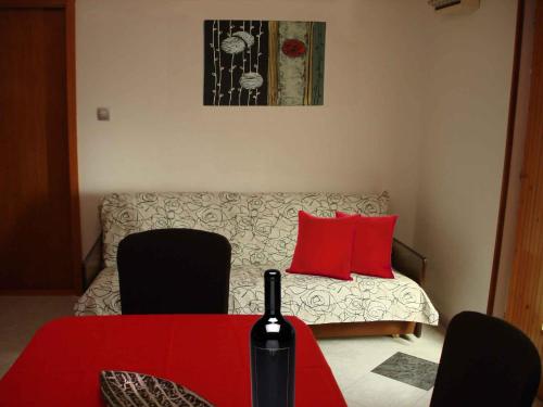 a room with a bed and a table with red pillows at Holiday home in Slatine/Insel Ciovo 6128 in Slatine