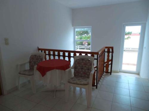 a dining room with a table and two chairs at Apartments in Sabunike/Zadar Riviera 7981 in Batalaži