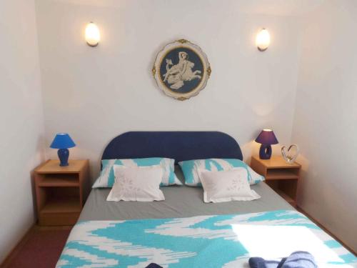a bedroom with a blue bed with two night stands at Apartment Trogir 6 in Okrug Donji