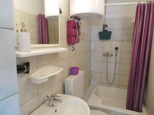 a bathroom with a sink and a shower and a toilet at Apartment Trogir 6 in Okrug Donji
