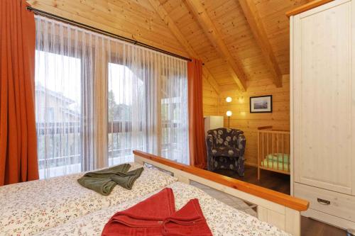 a bedroom with a bed and a large window at Holiday home in Zempin (Seebad) 3239 in Zempin