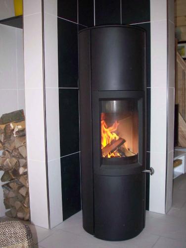 a black fireplace with a fire in it at Holiday home in Zempin (Seebad) 3239 in Zempin