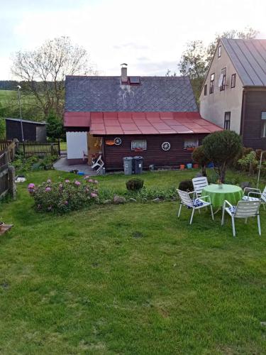 a barn with a table and chairs in a yard at Holiday home in Pernink - Erzgebirge 1672 in Pernink