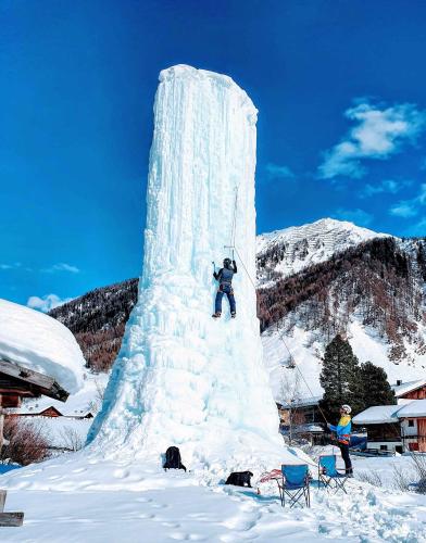 a man standing on top of a large ice tower in the snow at Apartment in Schmirn - Tirol 717 in Schmirn