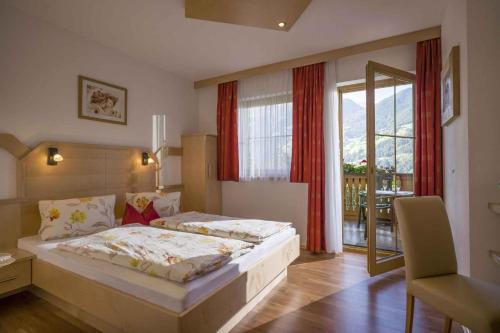 a bedroom with a large bed and a large window at Apartment Zell am Ziller 2 in Zell am Ziller